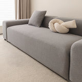 Corner of the stone grey smooth sofa cover near a window with soft daylight