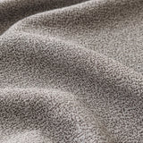 Macro of the fine soft-touch woven texture of the stone grey sofa cover