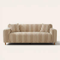 Caramel brown striped sofa cover on a three-seat sofa with matching cushions, front view on ivory
