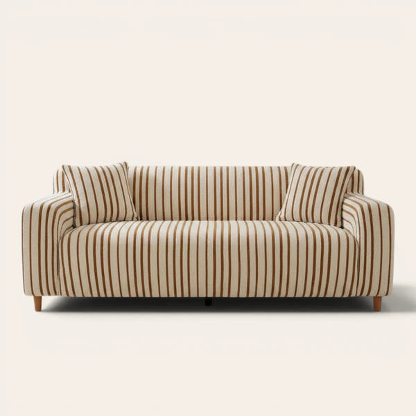 Caramel brown striped sofa cover on a three-seat sofa with matching cushions, front view on ivory