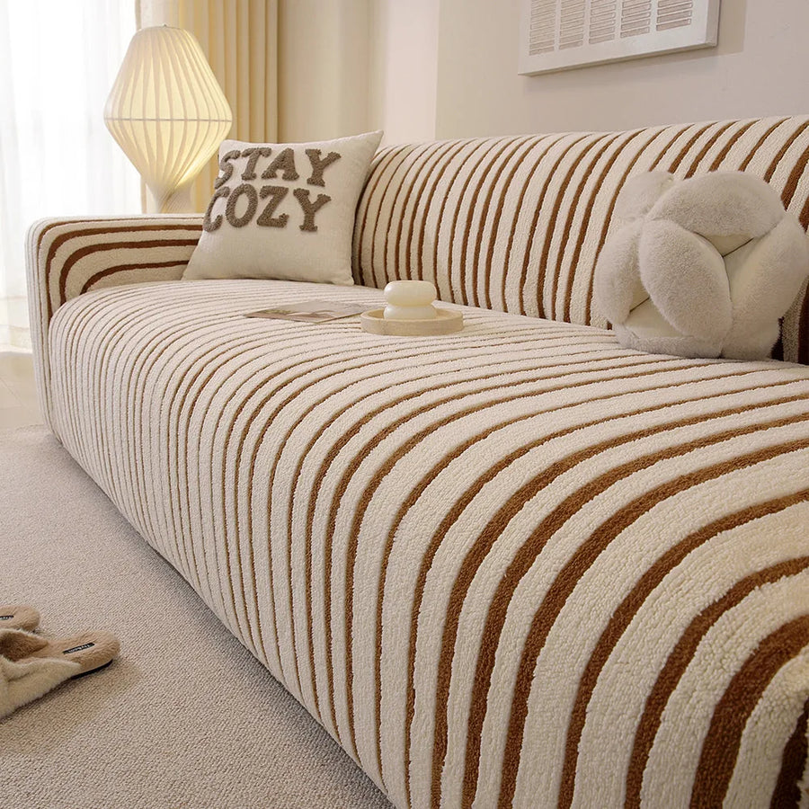 Angled close view of the caramel brown striped sofa cover over the seat and armrest