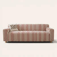 Crimson red striped sofa cover on a three-seat sofa with matching cushions, front view on ivory