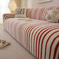 Angled view of the crimson red striped sofa cover over the seat and armrest in a living room