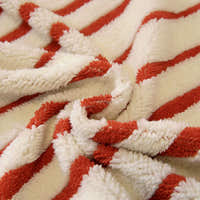 Macro of the plush crimson red and ivory striped sofa cover fabric texture