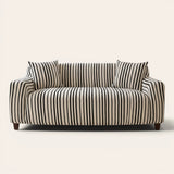 Midnight black striped sofa cover on a three-seat sofa with matching cushions, front view on ivory