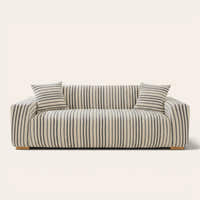 Ocean blue striped sofa cover fitted on a three-seat sofa with matching cushions, front view on ivory