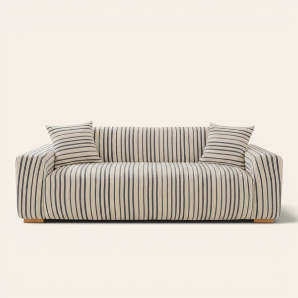 Ocean blue striped sofa cover fitted on a three-seat sofa with matching cushions, front view on ivory