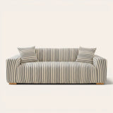 Ocean blue striped sofa cover fitted on a three-seat sofa with matching cushions, front view on ivory