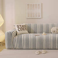 Ocean blue striped stretch sofa cover styled in a calm living room with a soft cushion