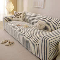 Angled view of the ocean blue striped sofa cover with vertical stripes over the seat and armrest