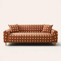 Caramel teddy sofa cover with white polka dots fitted on a three-seat sofa, front view on ivory