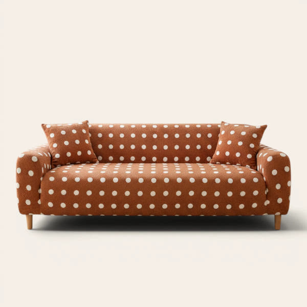 Caramel teddy sofa cover with white polka dots fitted on a three-seat sofa, front view on ivory