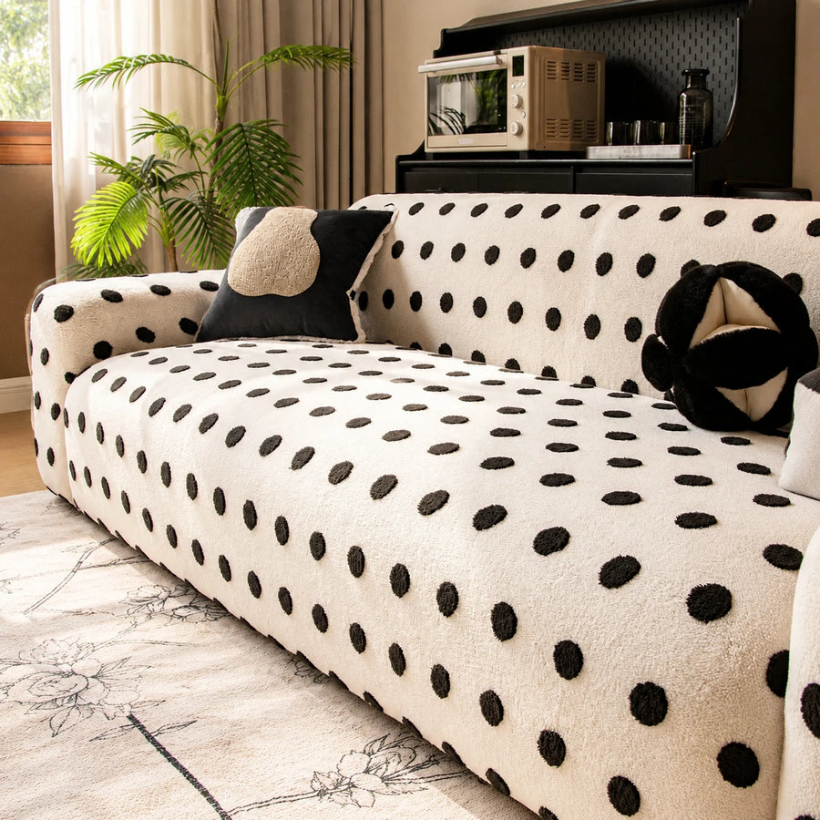 Sunlit angled view of the cream black teddy sofa cover with dark accent cushions