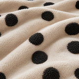 Macro close-up of the cream teddy sherpa with raised tufted black dots