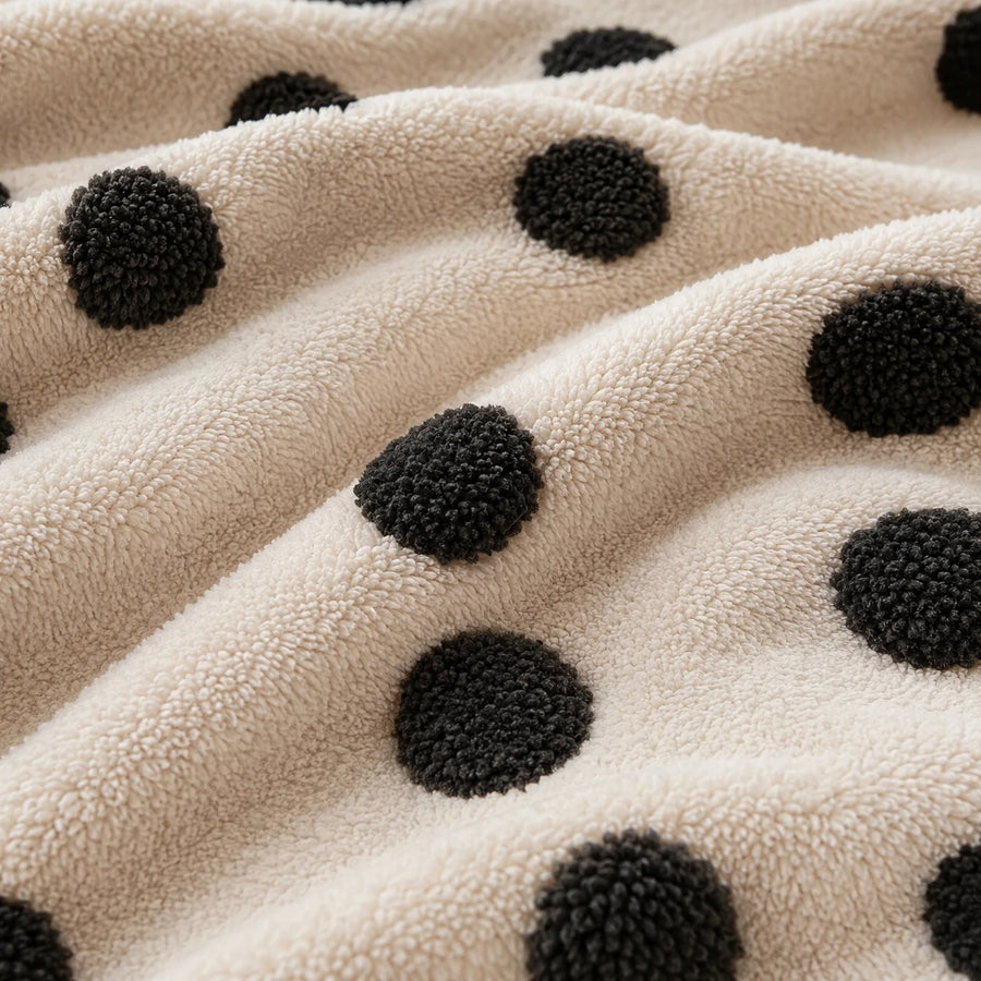 Macro close-up of the cream teddy sherpa with raised tufted black dots