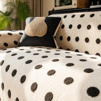 Close view of the cream black teddy sofa cover backrest with a dark accent cushion