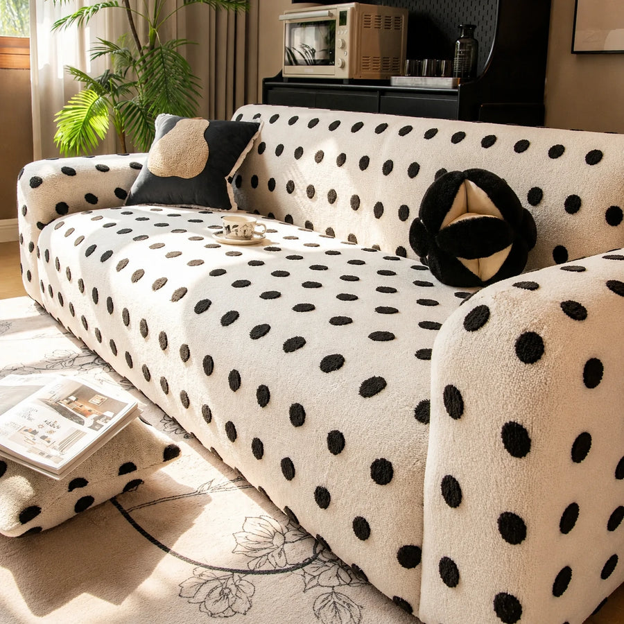 Angled living room view of the cream black teddy sofa cover with cushions and a floral rug