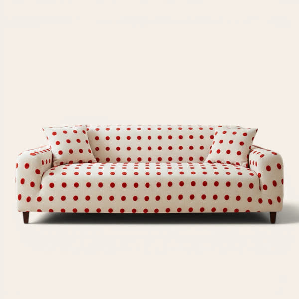 Cream red teddy sofa cover with red polka dots on a three-seat sofa, front view on ivory backdrop
