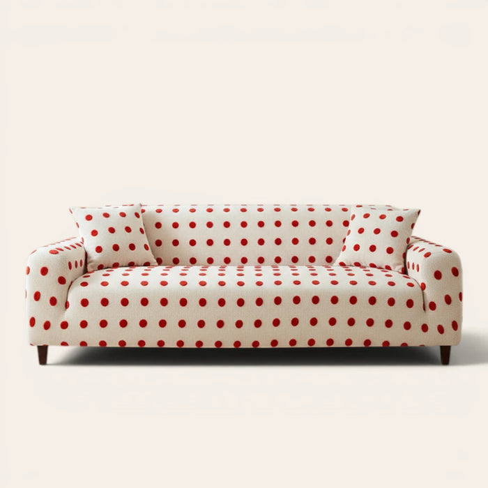 Cream red teddy sofa cover with red polka dots on a three-seat sofa, front view on ivory backdrop