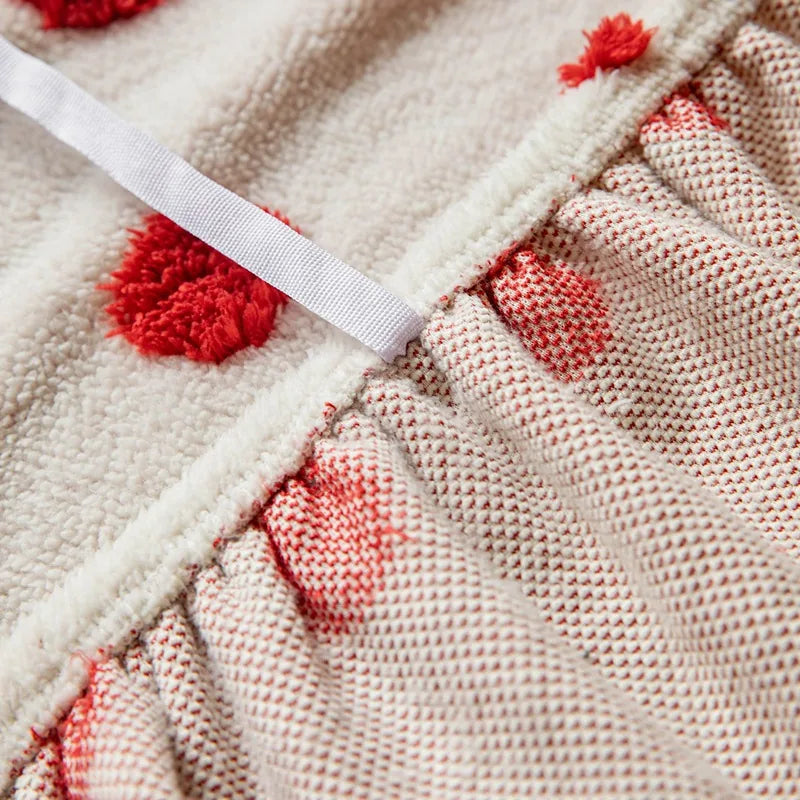 Detail of the elastic gathered hem and piping on the cream red teddy sofa cover