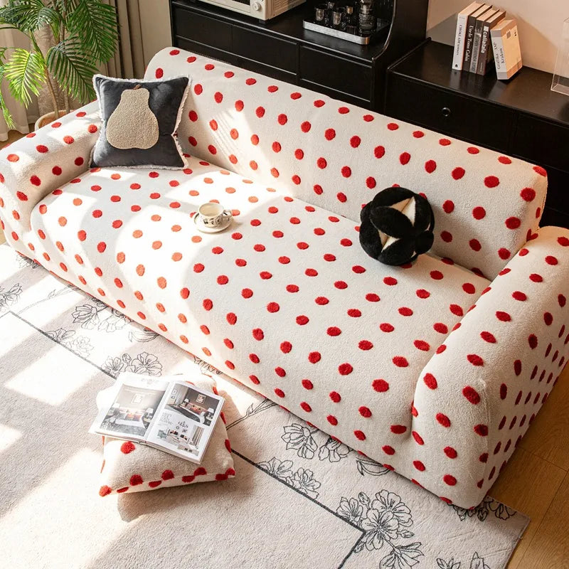 Angled living room view of the cream red teddy sofa cover with cushions and a floral rug