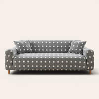 Grey snow teddy sofa cover with white polka dots on a three-seat sofa, front view on ivory backdrop