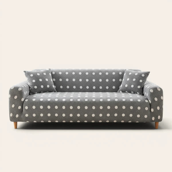 Grey snow teddy sofa cover with white polka dots on a three-seat sofa, front view on ivory backdrop