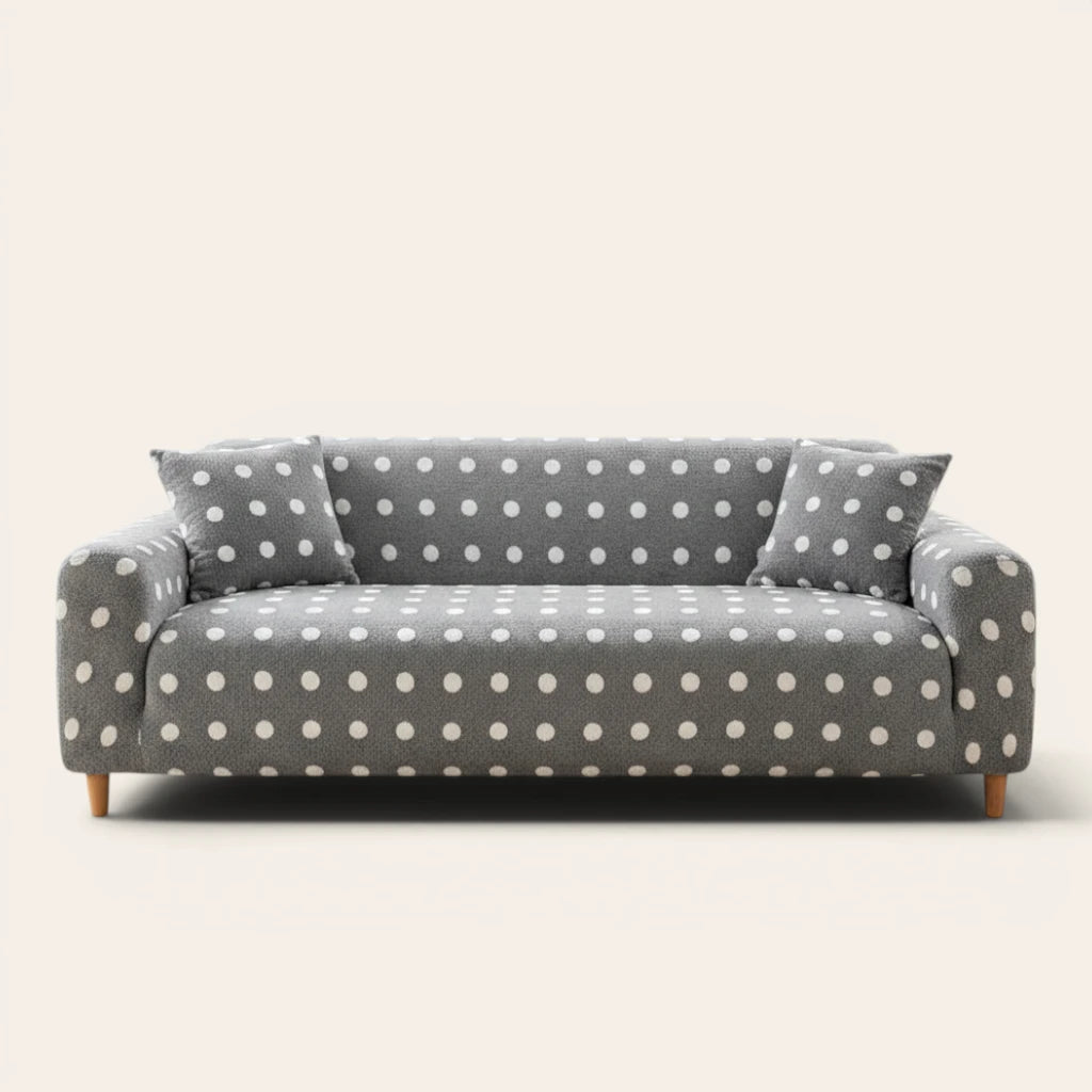 Grey snow teddy sofa cover with white polka dots on a three-seat sofa, front view on ivory backdrop