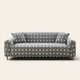 Grey snow teddy sofa cover with white polka dots on a three-seat sofa, front view on ivory backdrop