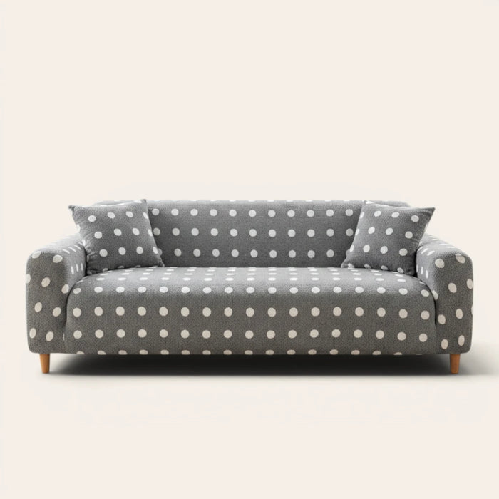 Grey snow teddy sofa cover with white polka dots on a three-seat sofa, front view on ivory backdrop