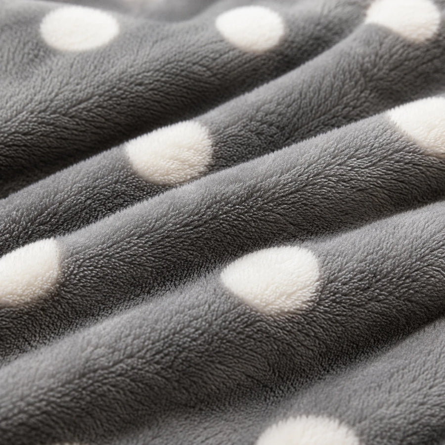 Macro close-up of the grey teddy fleece with raised white polka dots