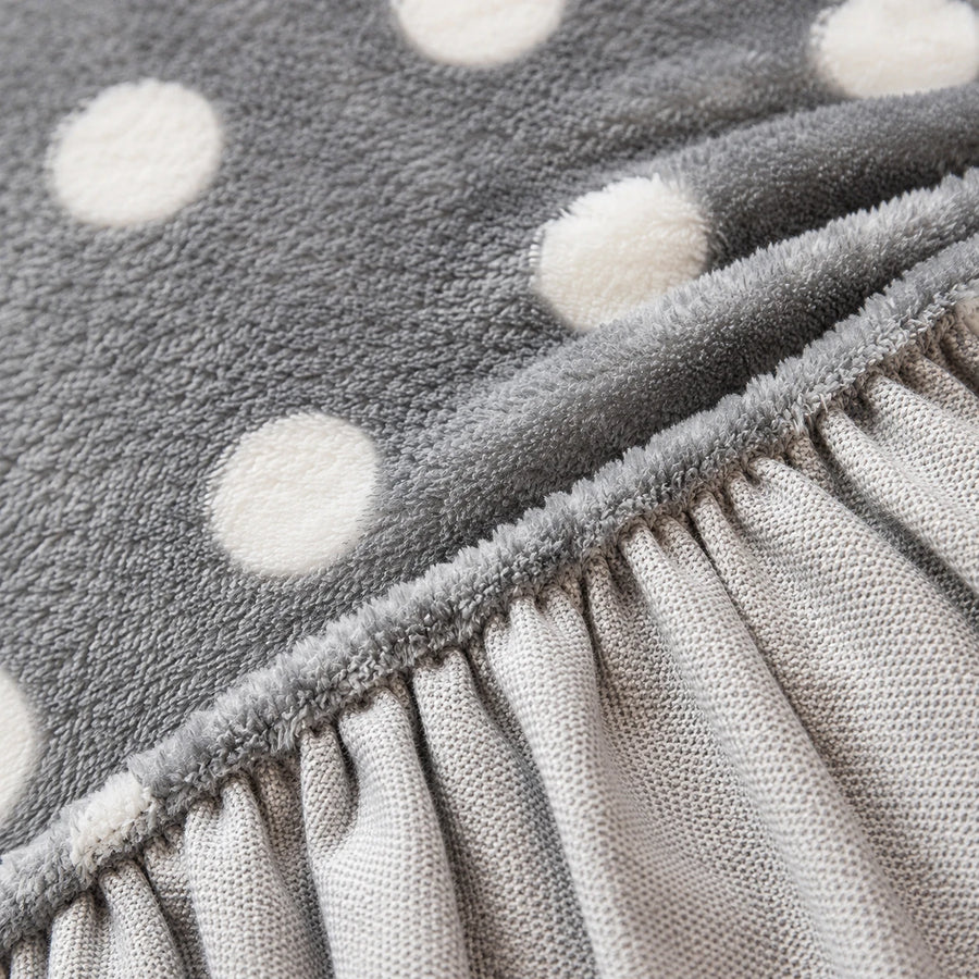 Detail of the elastic gathered hem on the grey snow teddy sofa cover underside