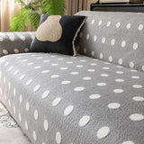 Close view of the grey snow teddy sofa cover backrest with a dark accent cushion