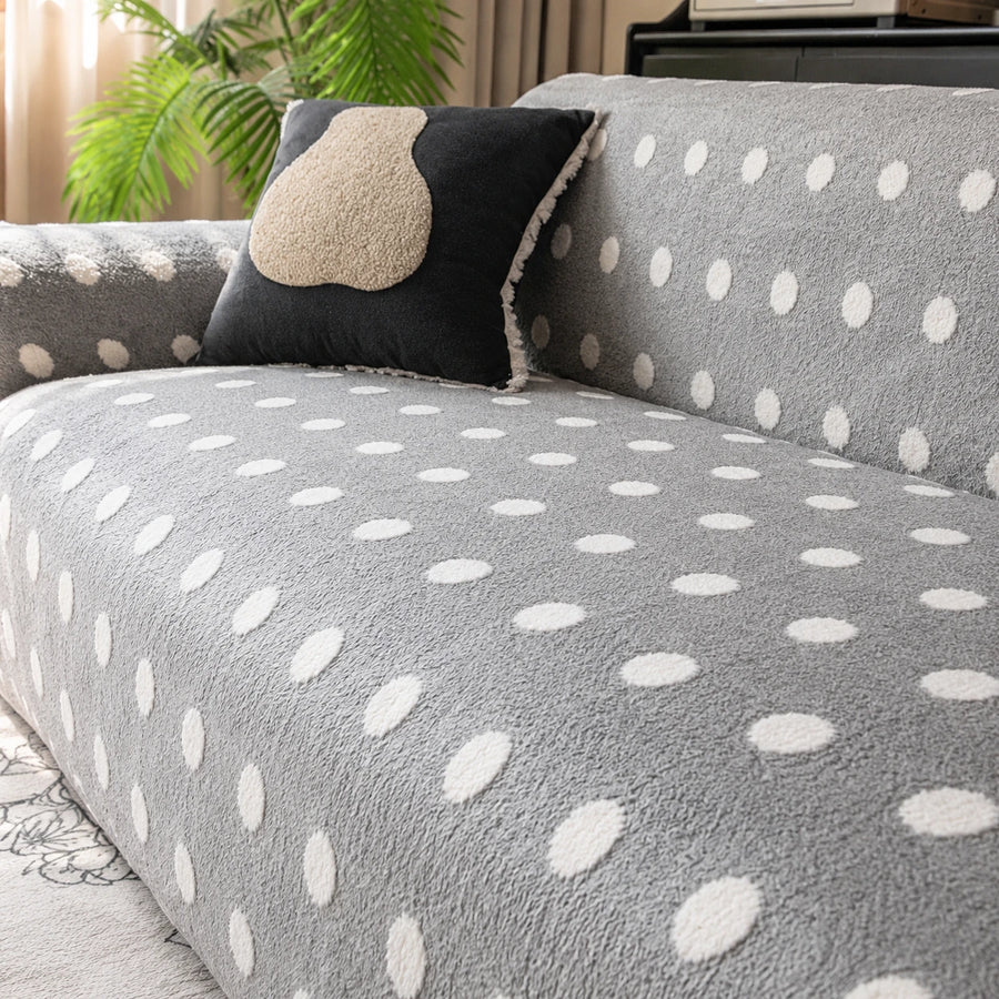 Close view of the grey snow teddy sofa cover backrest with a dark accent cushion