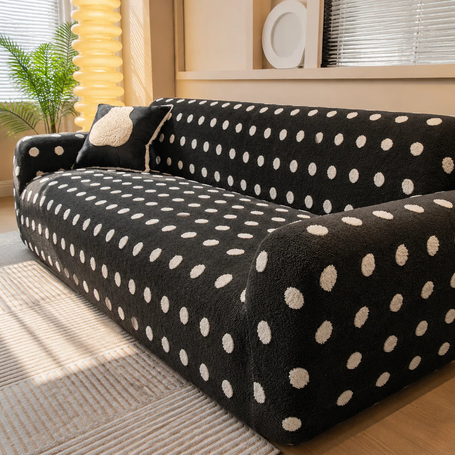 Corner view of the midnight dot teddy sofa cover with a matching polka dot cushion