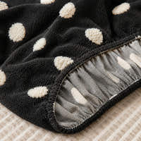 Detail of the elastic gathered hem on the midnight dot teddy sofa cover underside