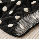 Detail of the elastic gathered hem on the midnight dot teddy sofa cover underside