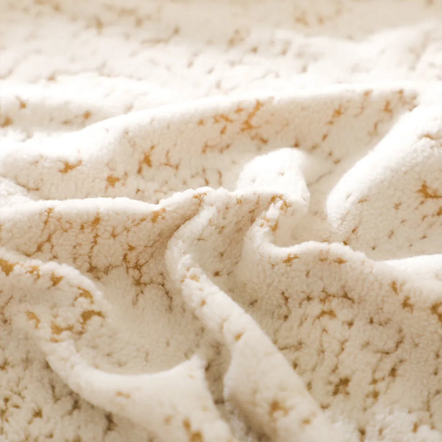 Macro close-up of the sand gold teddy texture, cream sherpa with golden marbled threads