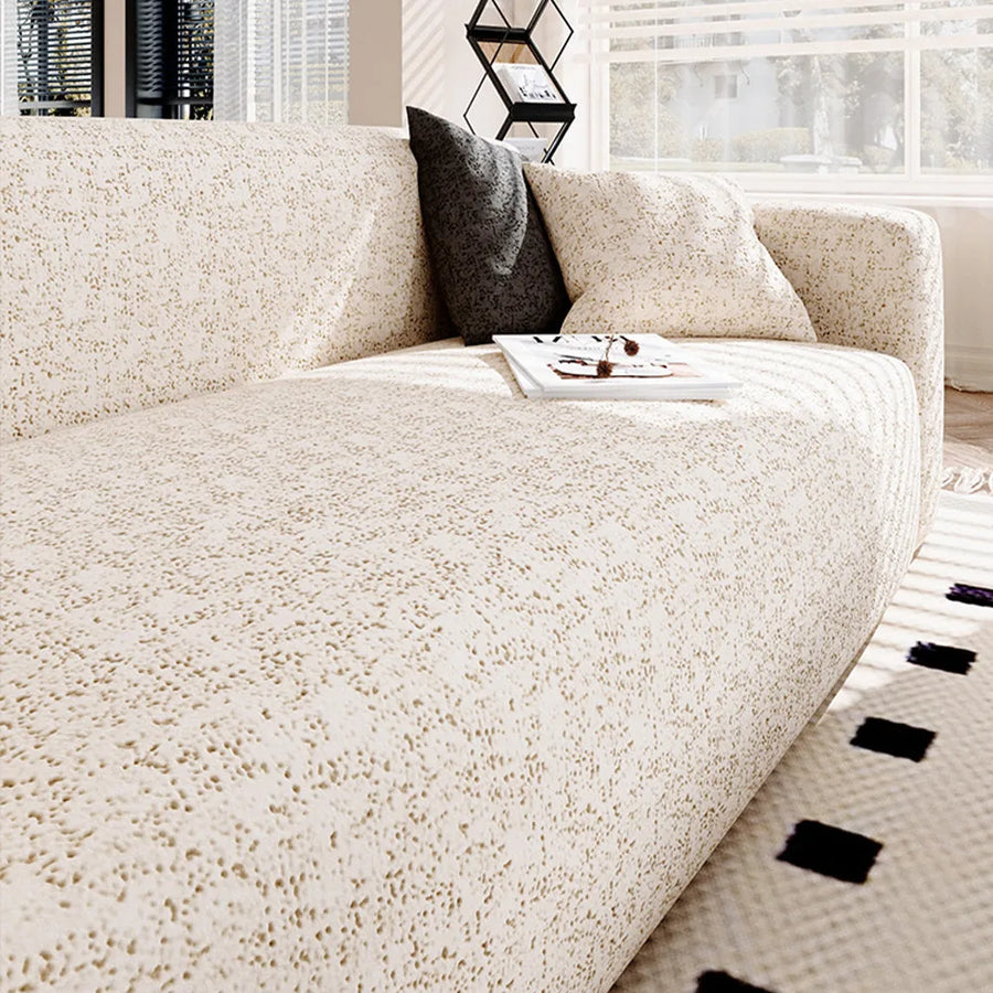 Sand gold teddy sofa cover styled with a dark grey cushion and a coffee tray by the window
