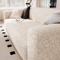 Corner view of the sand gold teddy sofa cover over the armrest with grey accent cushions