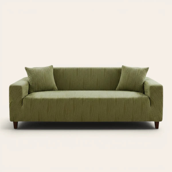Sage green velvet sofa cover fitted on a three-seat sofa, front view on ivory backdrop