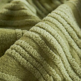 Macro close-up of the sage green velvet texture with its soft wavy ribbed pile