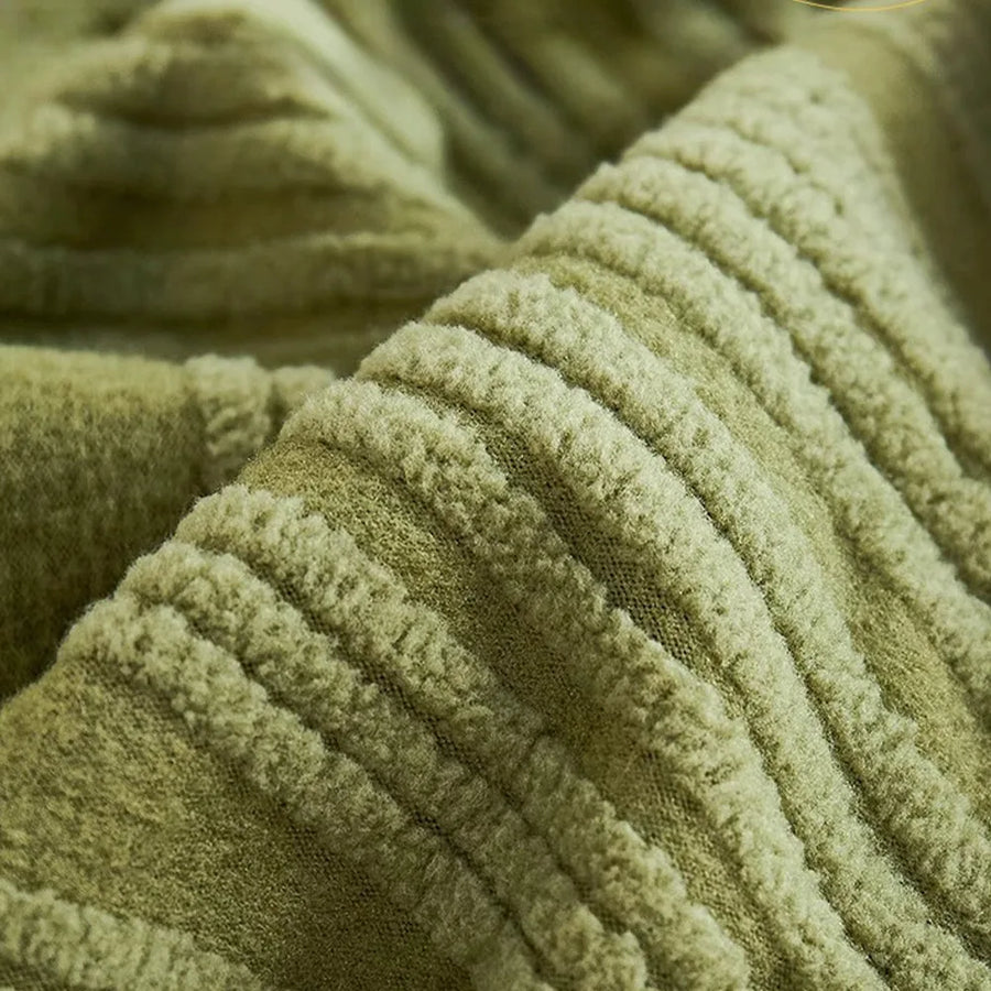 Macro close-up of the sage green velvet texture with its soft wavy ribbed pile