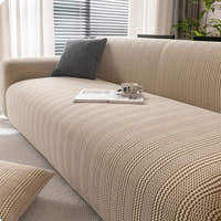 Almond cream waffle sofa cover styled in a bright living room with a grey cushion and coffee