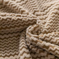 Macro close-up of the almond cream waffle texture with its chevron ribbed knit