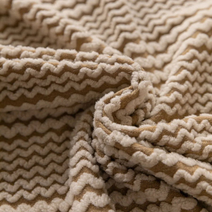 Macro close-up of the almond cream waffle texture with its chevron ribbed knit