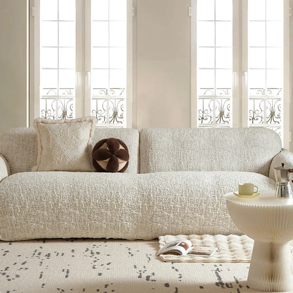 Ivory cream woven sofa cover styled in a bright living room with matching cushions and coffee