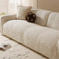 Angled corner view of the ivory cream woven sofa cover showing armrest and accent cushions