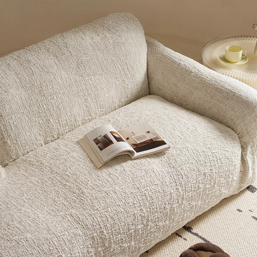 Close view of the ivory cream woven sofa cover texture across the seat and backrest