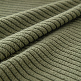 Macro of olive green corduroy showing the raised vertical cords of the weave